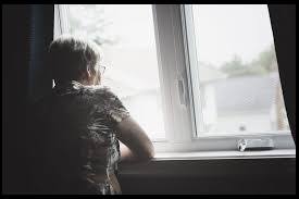 Senior citizens isolated looking out of window